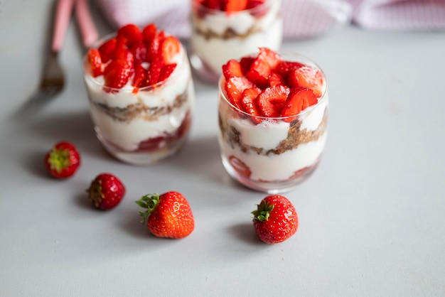 delicious homemade dessert with cream and strawberries in a glass