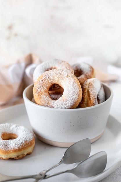 Delicious homemade donuts with sugar on a white stone background Selective focus