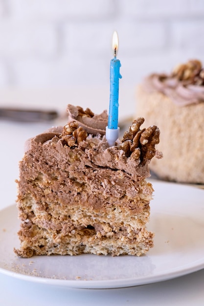 delicious homemade kiev cake with burning birthday candle