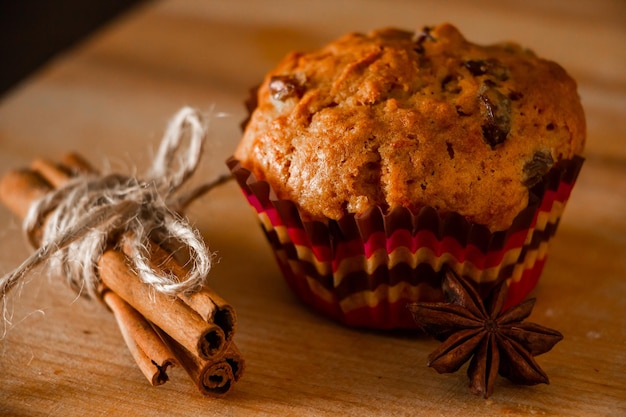 Delicious homemade muffins with raisins Christmas baking on a wooden background