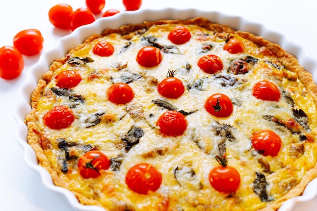 Delicious homemade quiche lorraine with chicken, tomato, mushrooms and cheese