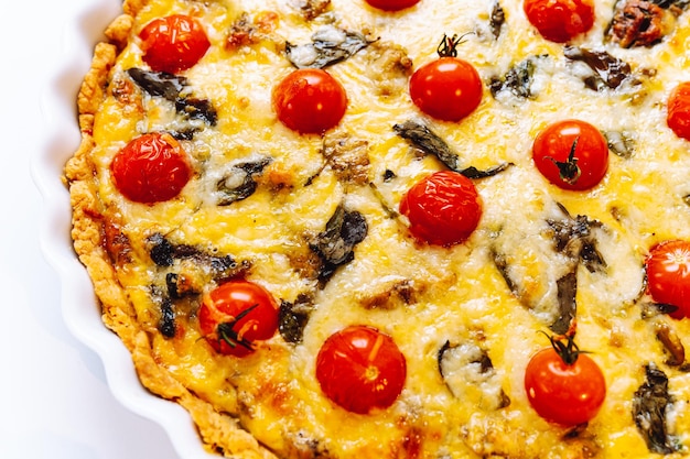 Delicious homemade quiche lorraine with chicken, tomato, mushrooms and cheese