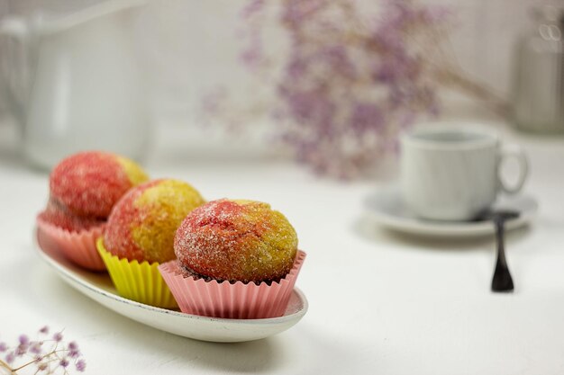 Delicious homemade round cookies with appetizing peachshaped filling Flowers mug and milk jug in the background