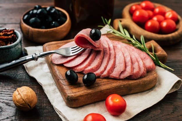 Delicious homemade sausage cut into pieces on a wooden board