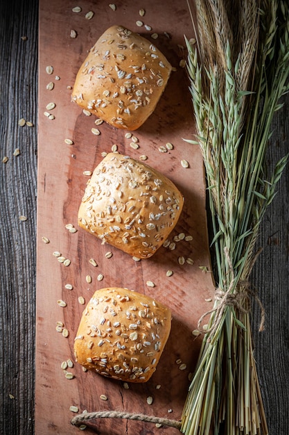 Delicious and hot oat buns with ears of grains