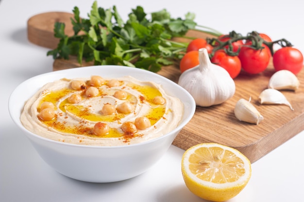 Delicious hummus with chickpeas, olive oil, lemon and pita bread. Vegetarian food concept.