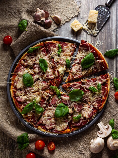 Delicious italian pizza with mushrooms is served on a wooden table