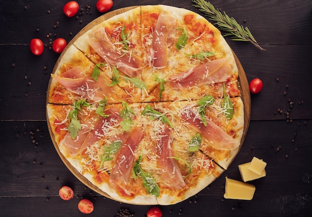 Delicious italian pizza with parma ham and rocket