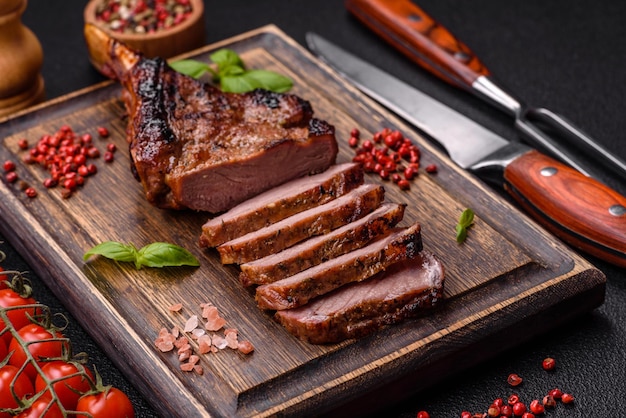 Delicious juicy beef steak on the bone tomahawk with salt spices and herbs