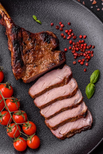 Delicious juicy beef steak on the bone tomahawk with salt spices and herbs