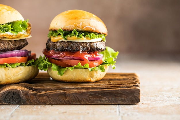 Delicious juicy grilled burger on wheat buns Studio macro shotFood Feast Party