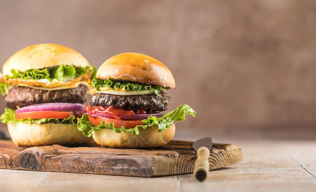 Delicious juicy grilled burger on wheat buns Studio macro shotFood Feast Party