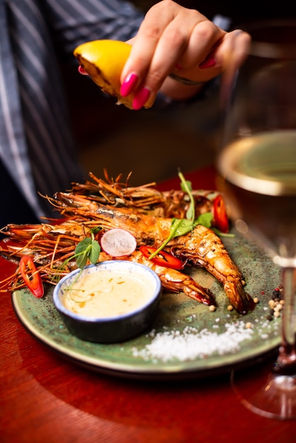 Delicious langoustine shrimps in restaurant on a wooden table tasty seafood with wine in cafe menu