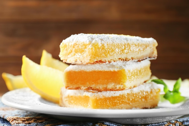 Delicious lemon pie bars stack on wooden backgroundclose up