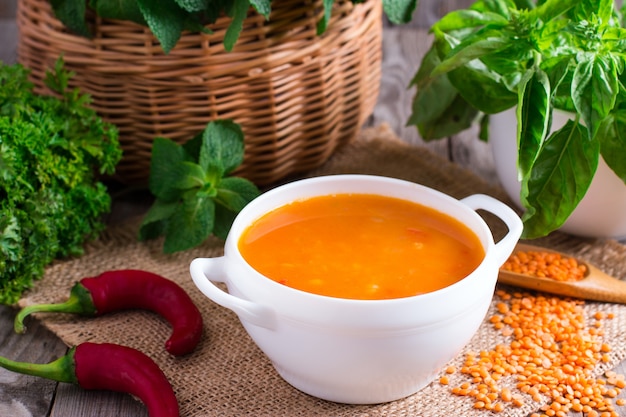 Delicious lentil cream-soup on table close-up