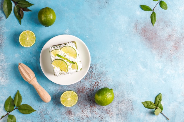 Delicious lime cake with fresh lime slices and limes.