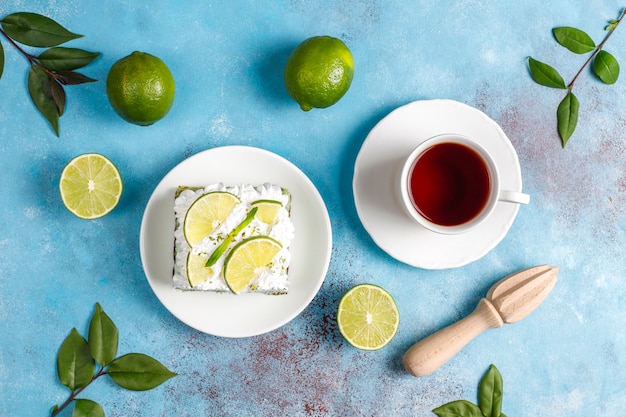 Delicious lime cake with fresh lime slices and limes.