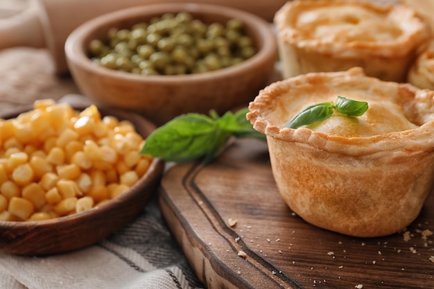 Delicious little meat pie on wooden board