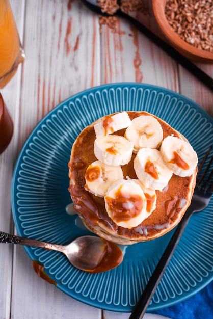 Delicious and lush pancakes with fresh fruits and berries, poured with salted caramel.