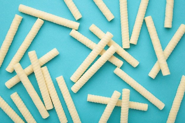 Delicious milk wafer rolls on blue background