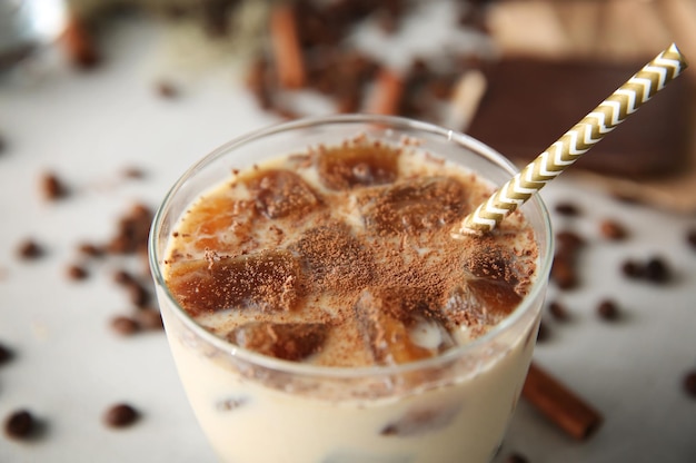 Delicious milkshake with chocolate in a glass on table closeup