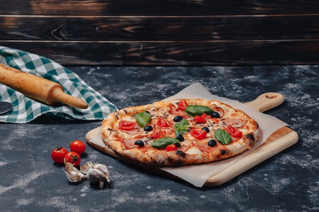 Delicious Neapolitan pizza on board with cherry tomatoes