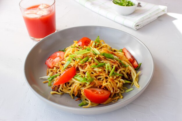 Delicious noodles in a plate with vegetables