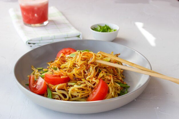 Delicious noodles in a plate with vegetables