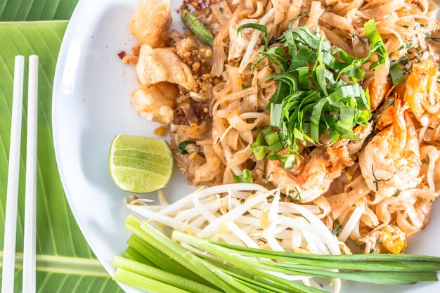 Delicious noodles with shrimp close-up on a plate, choose form top view.