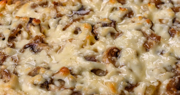 A delicious nutritious dish with meat mushrooms vegetables and potatoes baked in a creamy sauce in an oven