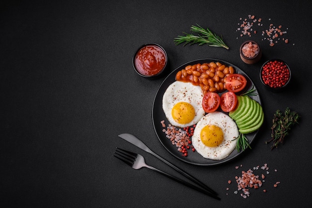 Delicious nutritious English breakfast with fried eggs tomatoes and avocado