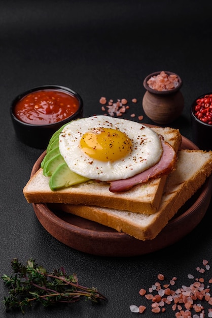 Delicious nutritious English breakfast with fried eggs tomatoes and avocado