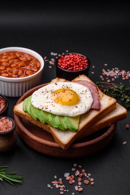 Delicious nutritious English breakfast with fried eggs tomatoes and avocado