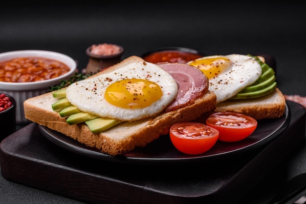 Delicious nutritious English breakfast with fried eggs tomatoes and avocado