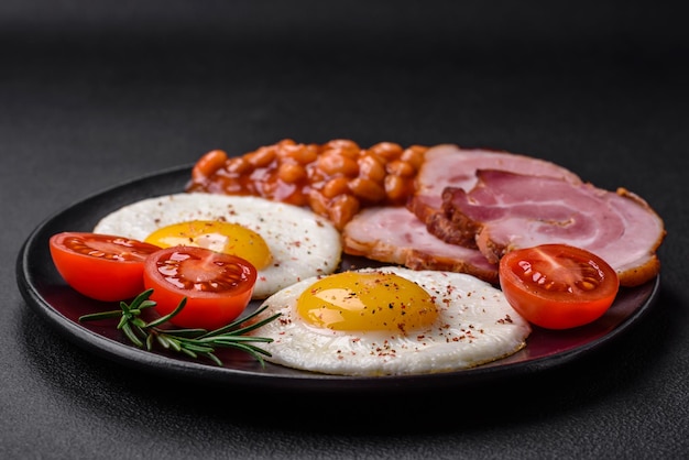 Delicious nutritious English breakfast with fried eggs and tomatoes