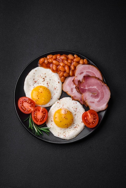 Delicious nutritious English breakfast with fried eggs and tomatoes