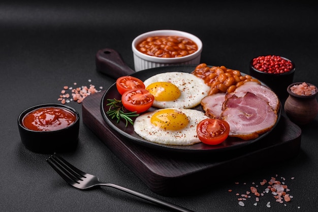 Delicious nutritious English breakfast with fried eggs and tomatoes