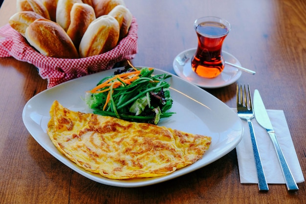 Delicious omlette and breakfast plate on the table.