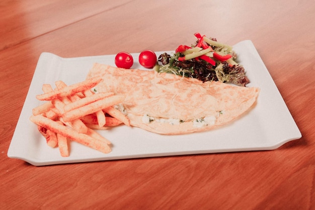 Delicious omlette and breakfast plate on the table.