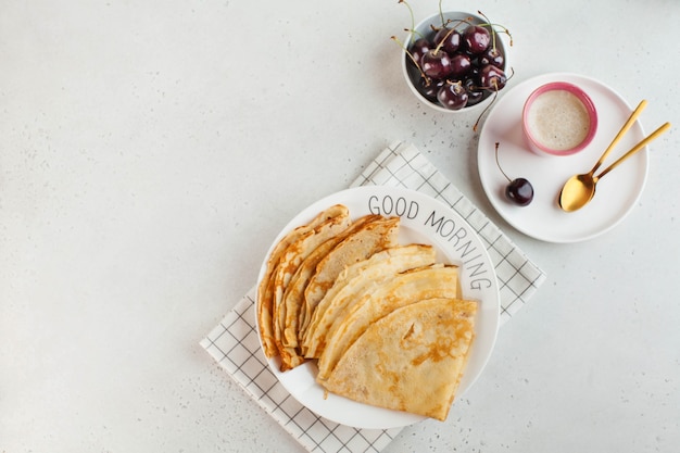 Delicious pancakes on plates decorated with berries coffee mug concept of breakfast good morning cop...