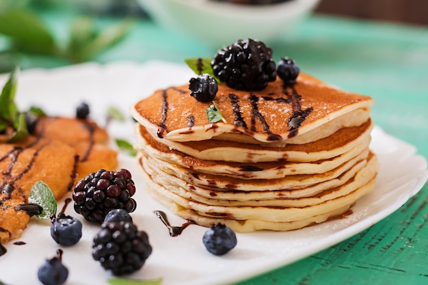 Delicious pancakes with blackberries and chocolate.