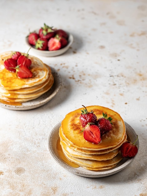 Delicious pancakes with strawberry on textured background Breakfast for two composition rustic style