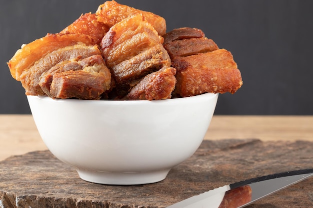 Delicious pancetta made with fried meat pork belly in a bowl. Selective focus.