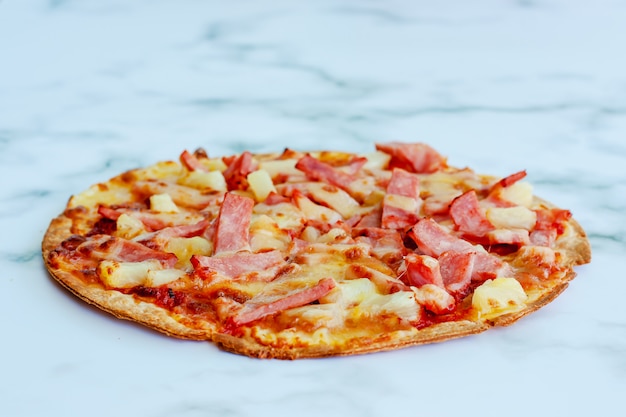 Delicious pizza on white marble background