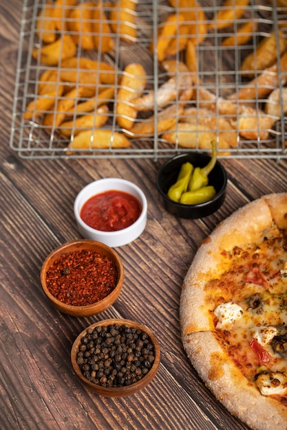 Delicious pizza with cheese and fresh vegetables on wooden table. 