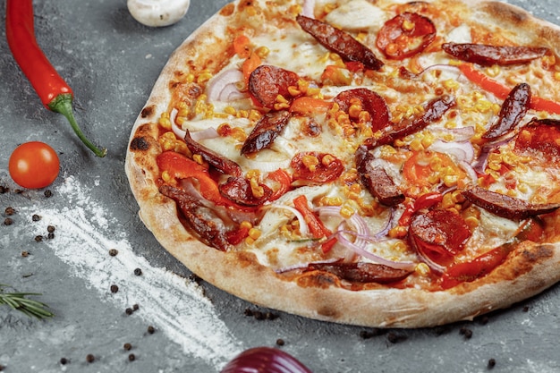 Delicious pizza with chicken fillet, ham, bacon, sausages and mozzarella isolated on white background