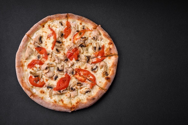 Delicious pizza with chicken tomatoes and cheese with salt and sauce