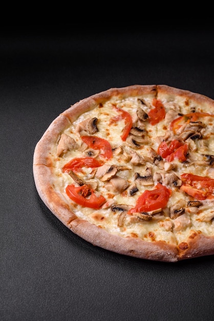 Delicious pizza with chicken tomatoes and cheese with salt and sauce