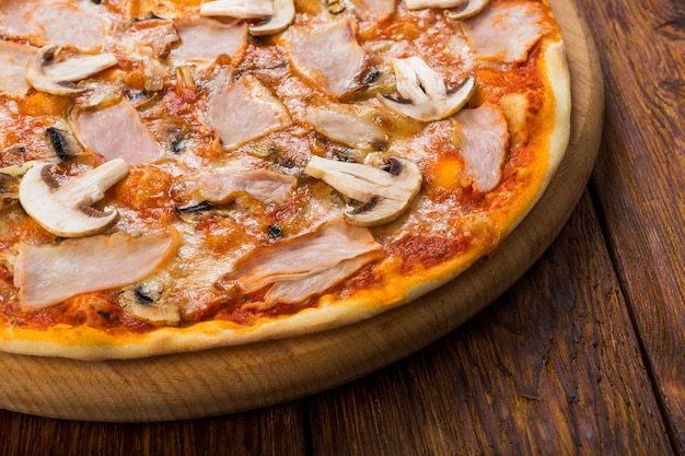 Delicious pizza with mushrooms and smoked chicken