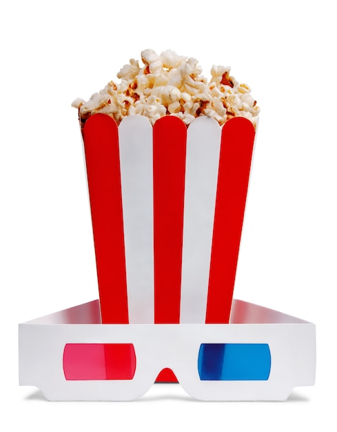 Delicious popcorn in decorative paper popcorn bucket and 3d glasses isolated on white background.